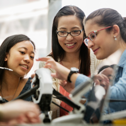 Students examining a drone project together